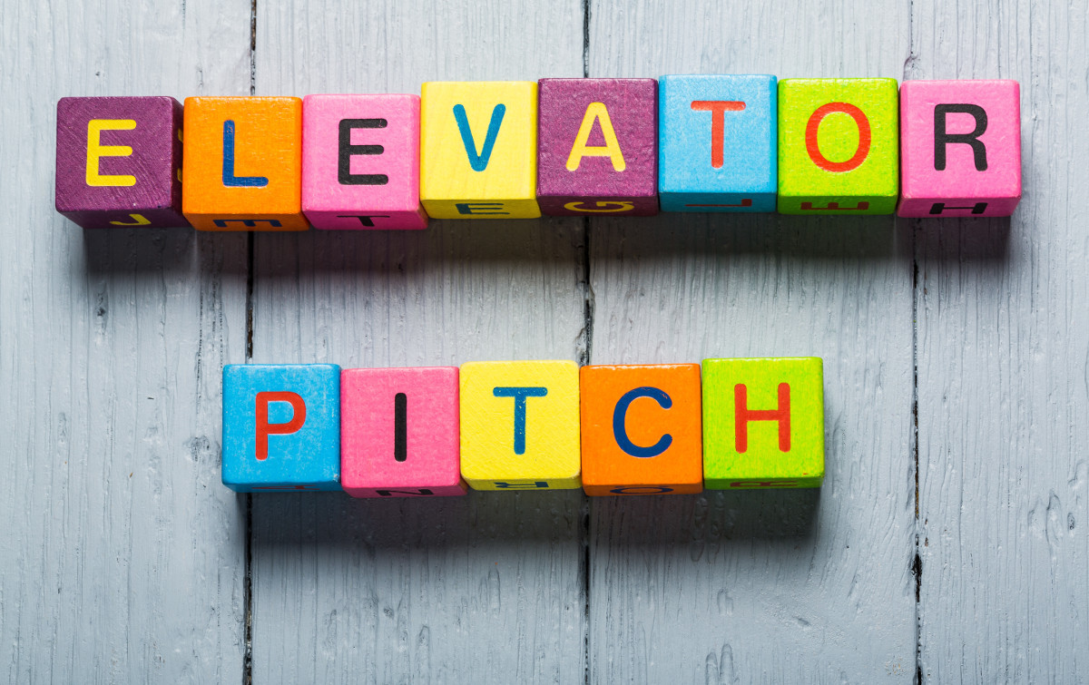 Elevator. Business man pointing to transparent board with text: Elevator Pitch